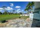 Expansive backyard with lush landscaping and an outdoor shower at 55 Mark Twain Ln, Rotonda West, FL 33947