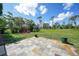 Spacious backyard with tiled patio and lush greenery, ideal for outdoor entertaining at 55 Mark Twain Ln, Rotonda West, FL 33947