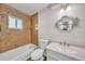Bathroom with brown tile in the shower, toilet and custom fish mirror at 55 Mark Twain Ln, Rotonda West, FL 33947