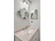 Charming bathroom featuring a unique fish-shaped mirror and updated sink at 55 Mark Twain Ln, Rotonda West, FL 33947