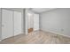 Empty bedroom with wood-look floor, neutral walls, and closet, offering a blank canvas for personalization at 55 Mark Twain Ln, Rotonda West, FL 33947