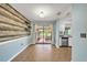 Dining room showcasing decorative wood wall, sliding door to lanai and stainless steel appliances at 55 Mark Twain Ln, Rotonda West, FL 33947