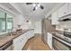 Updated kitchen featuring white cabinetry, stainless steel appliances, and a seamless layout at 55 Mark Twain Ln, Rotonda West, FL 33947