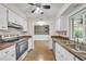 Functional kitchen with white cabinets, stainless appliances, and an open view to living space at 55 Mark Twain Ln, Rotonda West, FL 33947