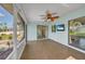 Comfortable screened lanai with ceiling fan, tv and sliding glass door at 55 Mark Twain Ln, Rotonda West, FL 33947