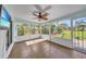 Relaxing lanai with tile floors, ceiling fan, and a beautiful view of the backyard at 55 Mark Twain Ln, Rotonda West, FL 33947