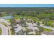 Aerial view of the community amenities including a pool, tennis courts, and a scenic lake at 576 Box Elder Ct, Englewood, FL 34223