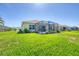 Manicured backyard with a screened lanai and a beautiful view of the surroundings at 576 Box Elder Ct, Englewood, FL 34223