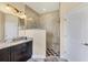 Bathroom featuring a glass enclosed shower, updated lighting and granite countertop at 576 Box Elder Ct, Englewood, FL 34223