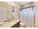 Bathroom featuring a granite countertop, wood vanity and shower/tub combination at 576 Box Elder Ct, Englewood, FL 34223