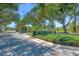 Welcoming community entrance with a manicured landscape and community sign at 576 Box Elder Ct, Englewood, FL 34223