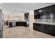 Gourmet kitchen with granite countertops, stainless appliances and dark wood cabinetry at 576 Box Elder Ct, Englewood, FL 34223