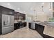 Stylish kitchen featuring granite countertops, stainless steel appliances and dark cabinetry at 576 Box Elder Ct, Englewood, FL 34223