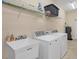 Bright laundry room with a utility sink, shelving, washer, and dryer at 576 Box Elder Ct, Englewood, FL 34223