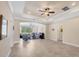Spacious living room with tile flooring, tray ceilings, recessed lighting and a backyard view at 576 Box Elder Ct, Englewood, FL 34223