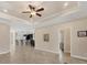 Open living space featuring tile flooring, tray ceilings, and a seamless flow into the kitchen at 576 Box Elder Ct, Englewood, FL 34223