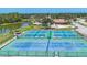 Community pickleball courts offer residents recreational opportunities with waterfront and clubhouse views at 576 Box Elder Ct, Englewood, FL 34223