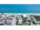Aerial view of the house in a coastal community, highlighting its proximity to the beach and waterfront lifestyle at 70 Wilhelm Dr, Englewood, FL 34223