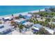 Aerial view of charming beach home with turquoise ocean backdrop at 70 Wilhelm Dr, Englewood, FL 34223