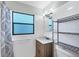 Clean bathroom features a vanity, window, and tiled walls at 70 Wilhelm Dr, Englewood, FL 34223