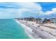 Stunning beachfront view with clear turquoise water and well-maintained homes along the shore at 70 Wilhelm Dr, Englewood, FL 34223