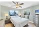 Cozy bedroom with large windows, ceiling fan, and neutral décor at 70 Wilhelm Dr, Englewood, FL 34223