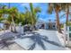 Charming beach home with white picket fence and shaded seating area at 70 Wilhelm Dr, Englewood, FL 34223