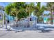 Charming home with a white picket fence and beautiful landscaping, including mature palm trees at 70 Wilhelm Dr, Englewood, FL 34223