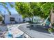 Inviting front yard with hammock, deck, and white stone landscaping, perfect for outdoor relaxation and enjoying the tropical atmosphere at 70 Wilhelm Dr, Englewood, FL 34223