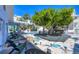Outdoor space featuring deck with seating, mature tree, landscaping, and covered porch at 70 Wilhelm Dr, Englewood, FL 34223