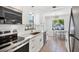 Well-equipped kitchen with stainless steel appliances, white cabinets, and a view to the dining area at 70 Wilhelm Dr, Englewood, FL 34223