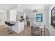 Bright kitchen features white cabinetry, stainless steel appliances, breakfast bar and adjacent dining area at 70 Wilhelm Dr, Englewood, FL 34223