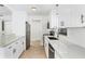 Modern kitchen boasts white cabinets, stainless steel appliances, and ample counter space at 70 Wilhelm Dr, Englewood, FL 34223