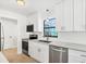 Contemporary kitchen features stainless steel appliances, white cabinets, and sleek countertops at 70 Wilhelm Dr, Englewood, FL 34223