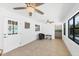 Bright living room with tile floors, white walls, and large windows for natural light at 70 Wilhelm Dr, Englewood, FL 34223