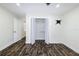 Bedroom with wood-look floors and closet, featuring a wall-mounted TV bracket at 700 Floral Ln, Port Charlotte, FL 33952