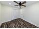 Bedroom features dark wood floors, a ceiling fan, and a closet at 700 Floral Ln, Port Charlotte, FL 33952