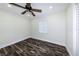 Cozy bedroom features dark wood floors, a ceiling fan, and a window at 700 Floral Ln, Port Charlotte, FL 33952