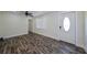 Bright living room featuring modern flooring, a ceiling fan, and a door with decorative glass at 700 Floral Ln, Port Charlotte, FL 33952