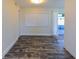Bright living room with modern flooring, closet, and access to a patio through sliding glass doors at 700 Floral Ln, Port Charlotte, FL 33952