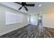 Bright living room with modern flooring, a ceiling fan, and a front door with decorative glass at 700 Floral Ln, Port Charlotte, FL 33952