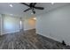 Bright living room featuring modern flooring, ceiling fan, and access to other rooms in the house at 700 Floral Ln, Port Charlotte, FL 33952