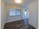 Bright living room with modern flooring, closet, and access to a patio through sliding glass doors at 700 Floral Ln, Port Charlotte, FL 33952