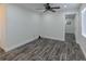 Bright room featuring modern flooring, ceiling fan, and access to other rooms in the house at 700 Floral Ln, Port Charlotte, FL 33952