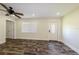 Bright living room with modern flooring, a ceiling fan, and a front door with decorative glass at 700 Floral Ln, Port Charlotte, FL 33952