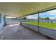 Covered and screened patio overlooking a large, lush backyard with white fencing at 700 Floral Ln, Port Charlotte, FL 33952