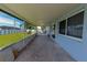 Covered and screened patio overlooking a large, lush backyard with white fencing at 700 Floral Ln, Port Charlotte, FL 33952