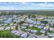 Scenic aerial view of a tranquil community featuring cozy homes surrounding a picturesque lake at 742 Portwine Ct # 17, Englewood, FL 34223