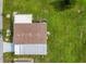 An aerial view displays a well maintained roof and lush green lawn surrounding this quaint mobile home at 742 Portwine Ct # 17, Englewood, FL 34223