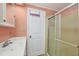 Cozy bathroom featuring a standalone shower, a simple white door, and a well-lit vanity area at 742 Portwine Ct # 17, Englewood, FL 34223